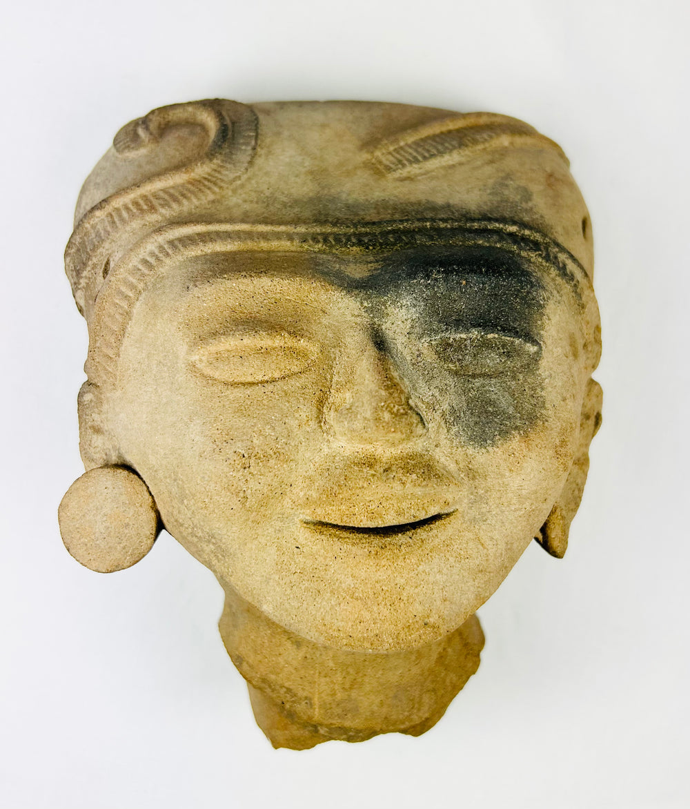 Angled top view displaying sculpted coiffure and mineral deposits on surface