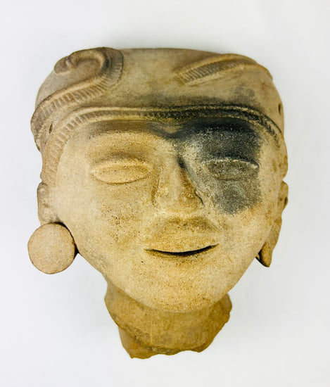 Angled top view displaying sculpted coiffure and mineral deposits on surface