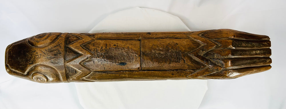 Overhead view of the tribal fish drum showing symmetrical carved body and aged patina.