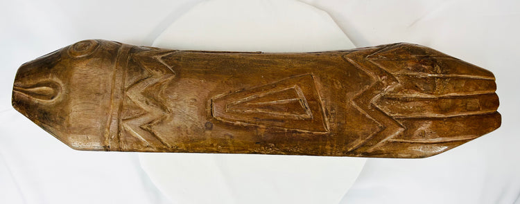 Flat top perspective of carved fish drum revealing surface patterns and triangular engravings