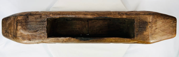 Underside view of hollow wooden fish drum showing interior cavity used for resonance