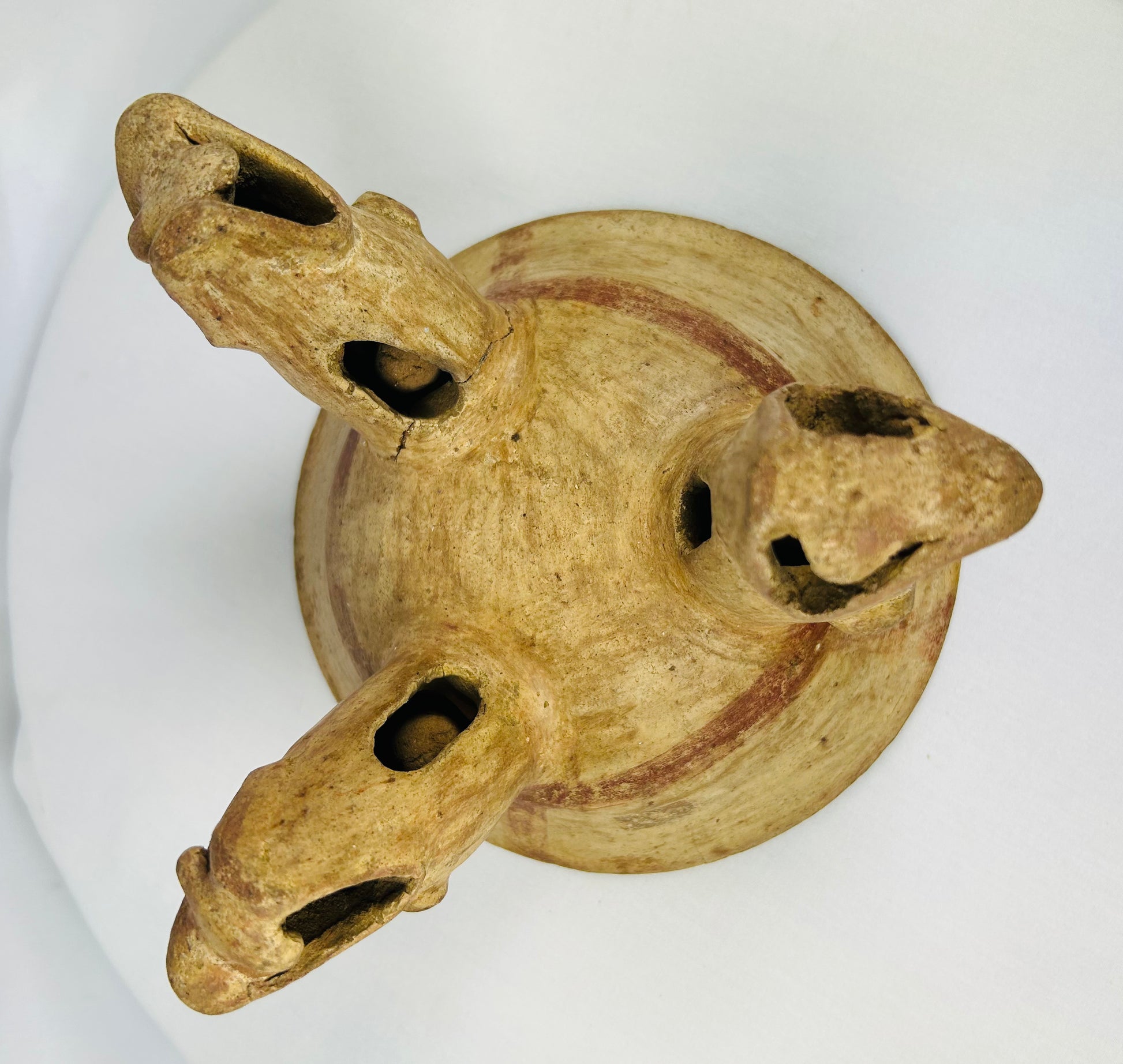 Underside view of tripod bowl showing three hollow animal-head supports, Costa Rican origin