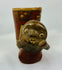Front view of Pre-Columbian effigy cup showing expressive modeled face and ochre slip surface