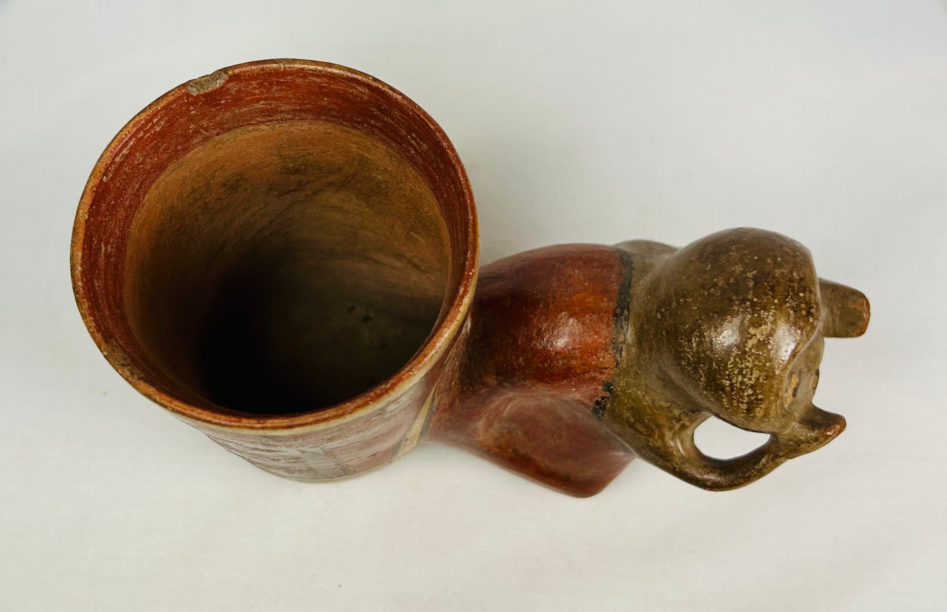 Pre-Columbian ceramic effigy beaker featuring human face and rectilinear patterning, 800–1200 AD