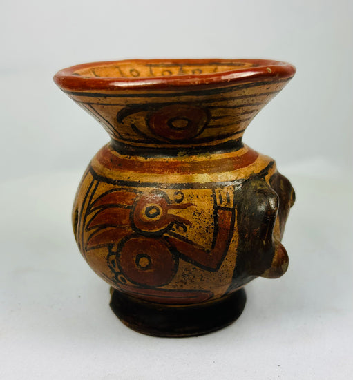 Right side of ancient Nicoya effigy vessel with expressive face and red-black geometric motifs