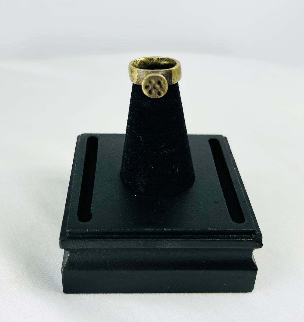 Top-down shot of Roman bronze ring emphasizing circular bezel alignment and craftsmanship.