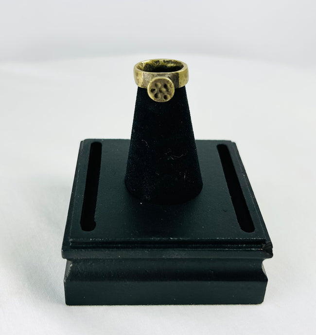 Top-down shot of Roman bronze ring emphasizing circular bezel alignment and craftsmanship.
