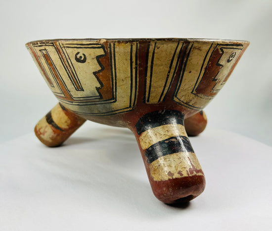 Close-up of painted surface on Pre-Columbian bowl showing mineral pigment details and natural patina.