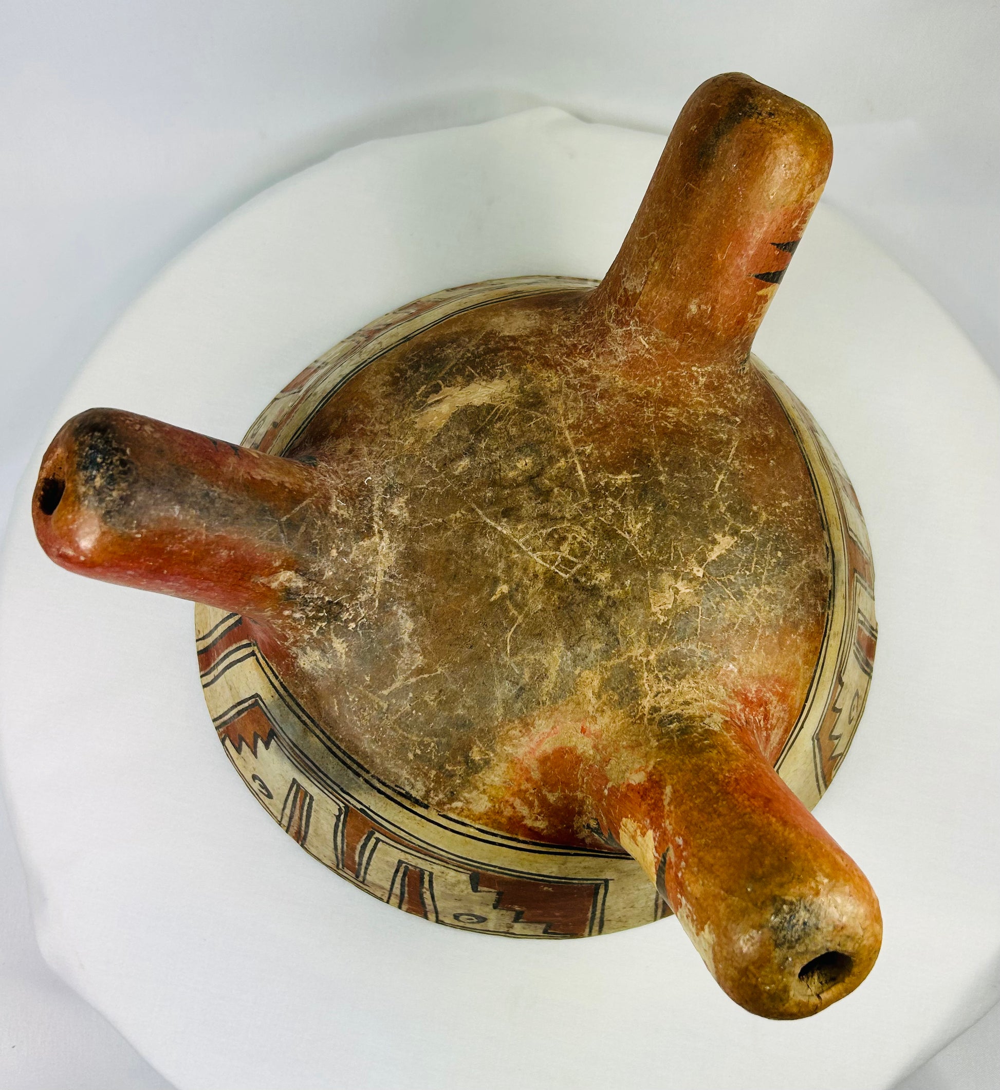 Bottom view of Nicoya tripod bowl displaying hollow rattle legs and construction craftsmanship.