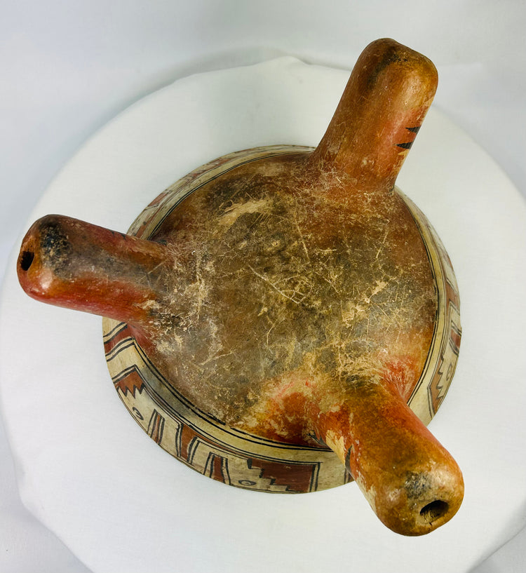 Bottom view of Nicoya tripod bowl displaying hollow rattle legs and construction craftsmanship.
