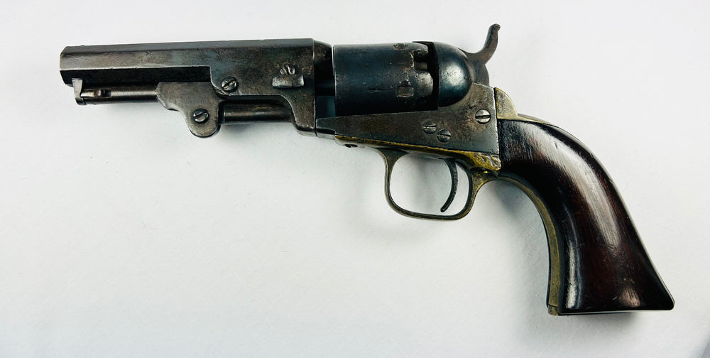 Mid-1800s Colt 1849 Pocket Revolver with engraved cylinder, octagonal barrel, brass trigger guard, walnut grip