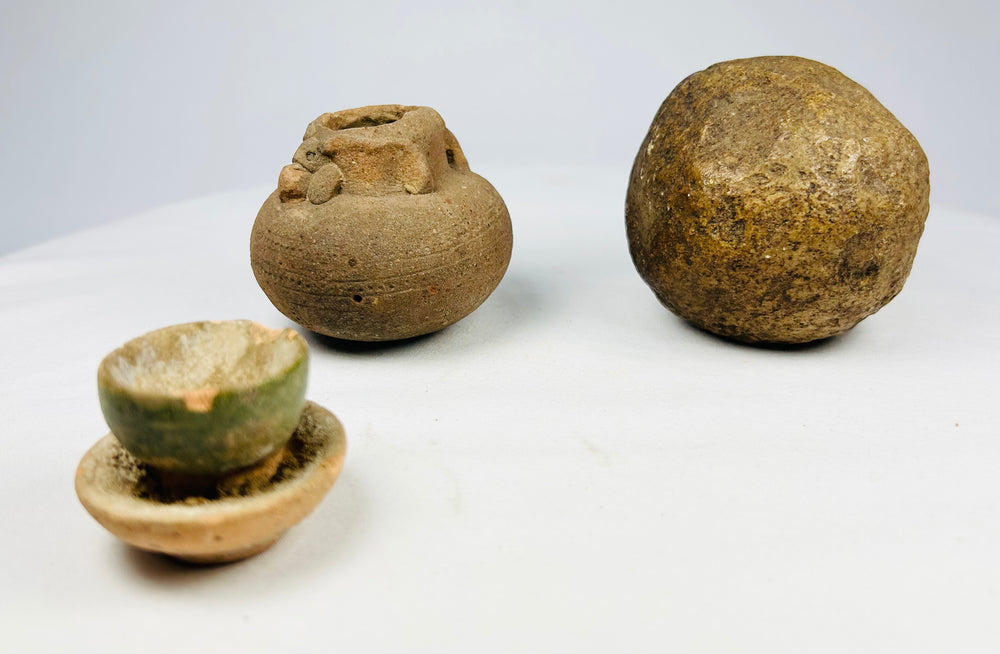 Rounded stone artifact with weathered surface, early utilitarian tool from the Indian subcontinent or Southeast Asia.
