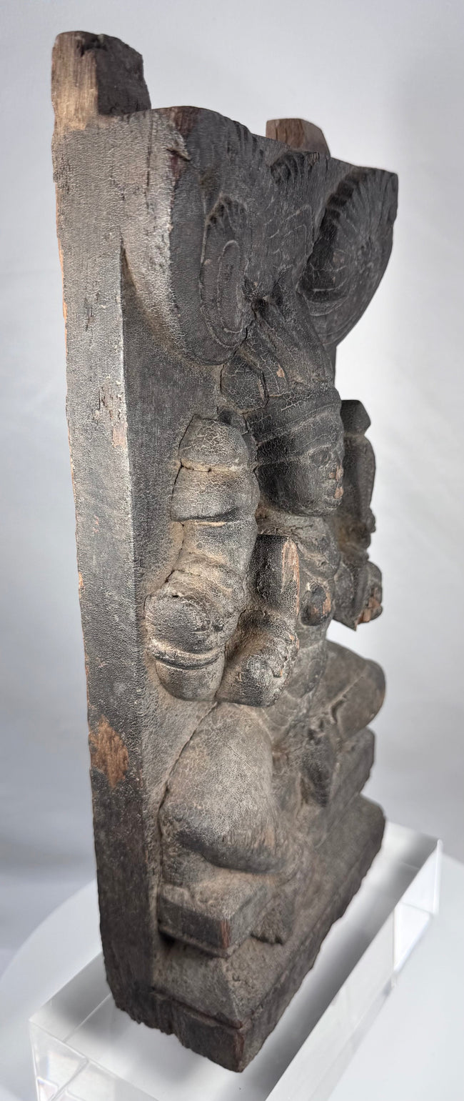 Indian religious carving with aged timber surface and projecting wooden tenons
