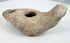 Late antique ceramic oil lamp with mineral deposits and weathered surface