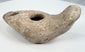 Late antique ceramic oil lamp with mineral deposits and weathered surface