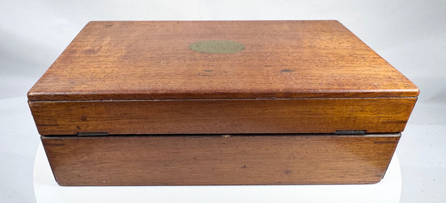 Antique wooden medical chest with hinged lid, keyhole and historic contents