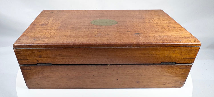 Antique wooden medical chest with hinged lid, keyhole and historic contents