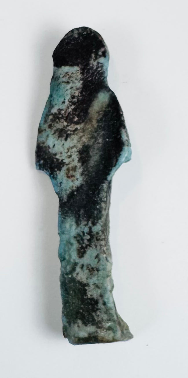 Ancient blue-green ushabti with simplified facial features and projecting feet