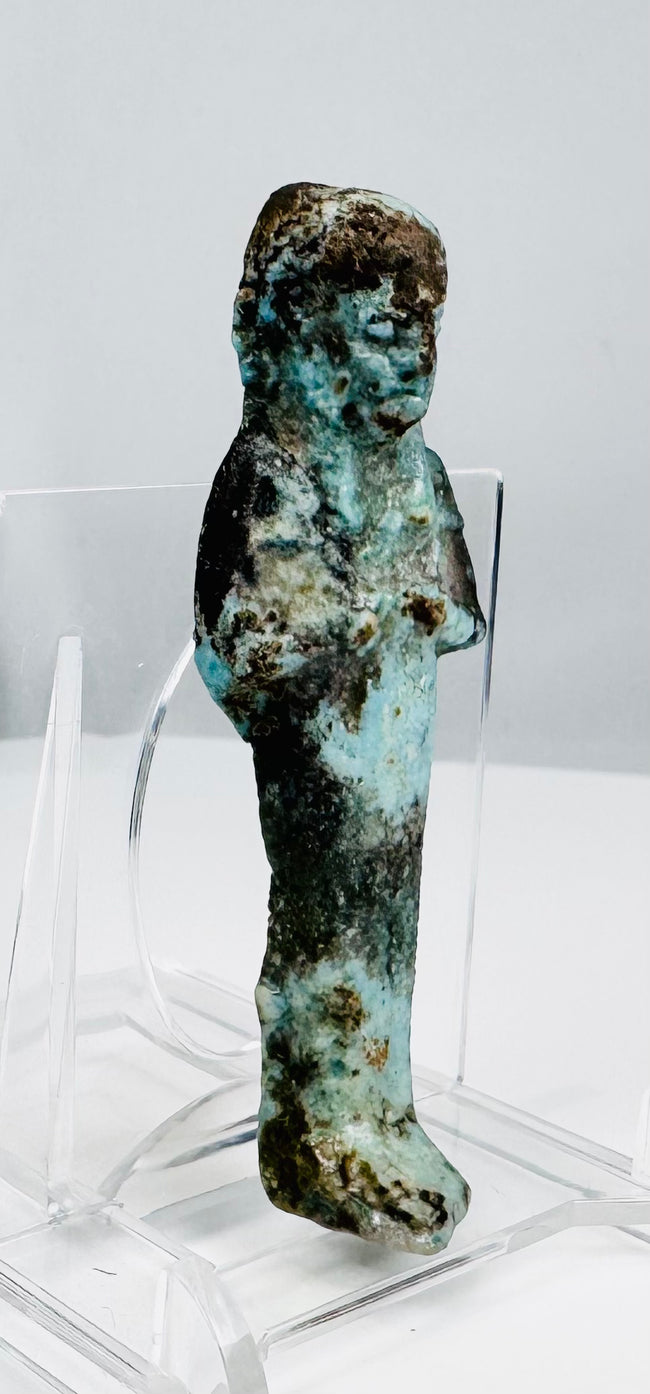 Egyptian burial figure with surviving turquoise glaze and dark mineral patina
