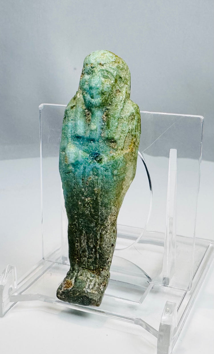 Ptolemaic Egyptian blue-green faience ushabti with crossed arms and tripartite wig