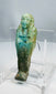 Ptolemaic Egyptian blue-green faience ushabti with crossed arms and tripartite wig
