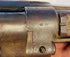 Close-up of engraved proof marks on the metal receiver of a Victorian-era Enfield Snider Conversion rifle.