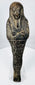 Front view of an ancient Egyptian dark stone ushabti dating to circa 700–600 BCE