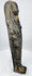 Side view of an ancient Egyptian carved stone ushabti showing its elongated mummiform profile