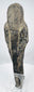 Rear view of an ancient Egyptian stone ushabti showing the dorsal pillar and aged mineral deposits
