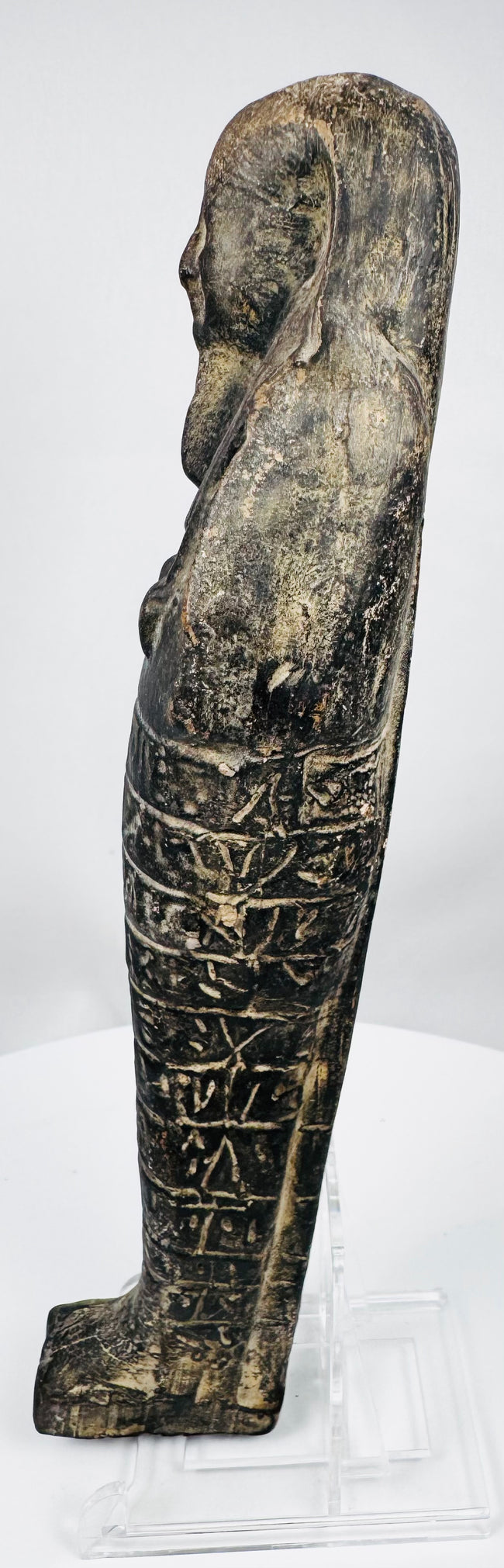 Ancient Egyptian funerary shabti with extensive hieroglyphic inscription and dark charcoal stone surface