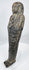 Close-up of deeply incised hieroglyphic registers on an ancient Egyptian dark stone ushabti