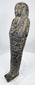 Close-up of deeply incised hieroglyphic registers on an ancient Egyptian dark stone ushabti