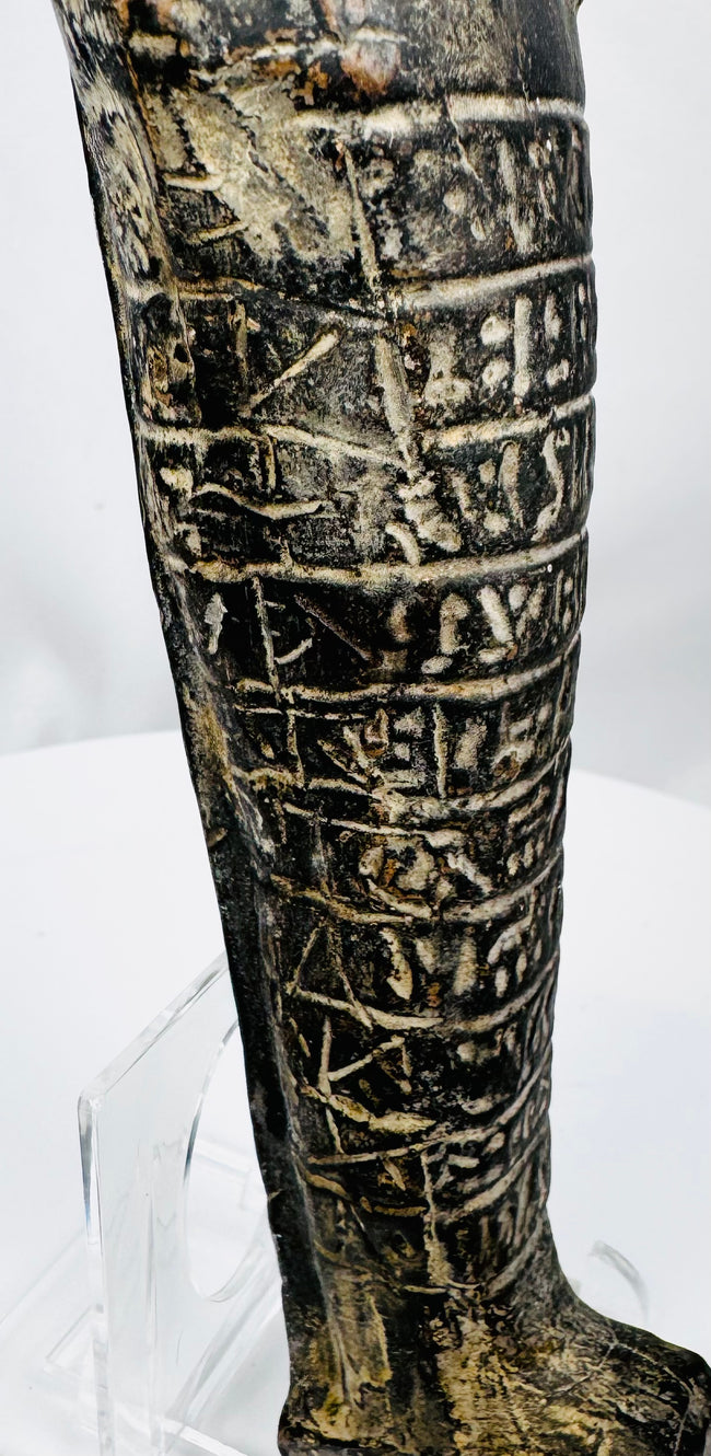 Lower body of an ancient Egyptian stone ushabti showing horizontal hieroglyphic registers and integral base