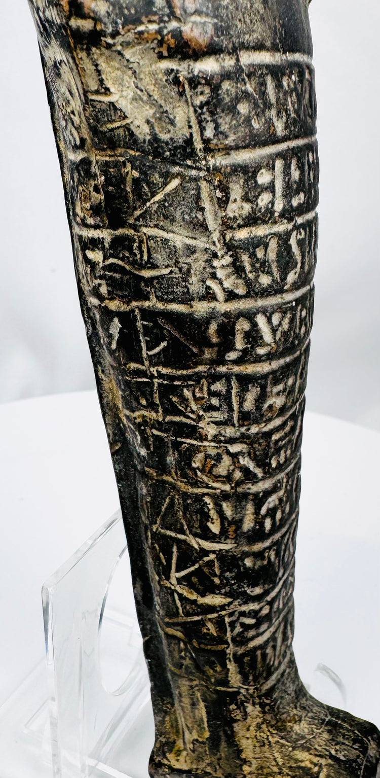 Lower body of an ancient Egyptian stone ushabti showing horizontal hieroglyphic registers and integral base