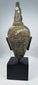 Ancient Thai Buddhist bronze sculpture with brown, red and green patination