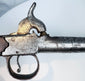 Curved wooden grip and bag-shaped butt of British pocket pistol