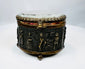 Antique French casket with detailed figures, furniture, and architectural scenes