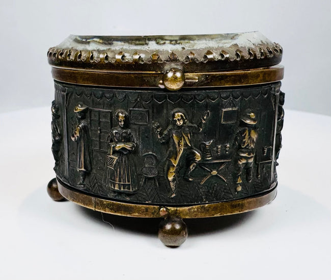Victorian-era French metal casket with bas-relief tavern scene