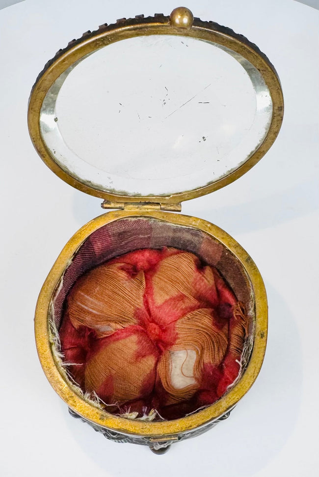 Beveled glass lid and decorative border on a French jewelry box