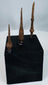 Three ancient iron spearheads mounted on a black wooden block