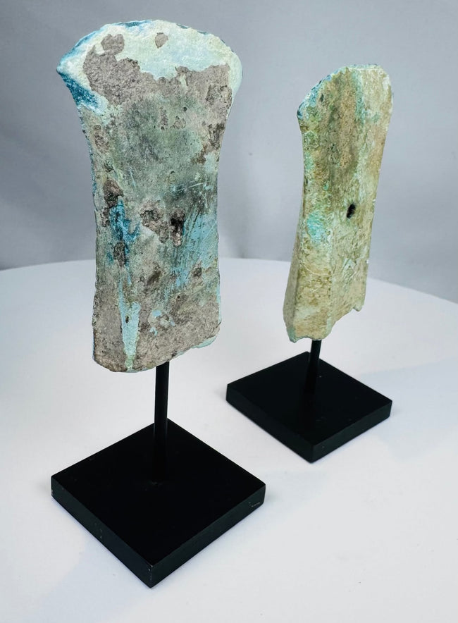 Archaeological bronze axes with green and blue-green patina