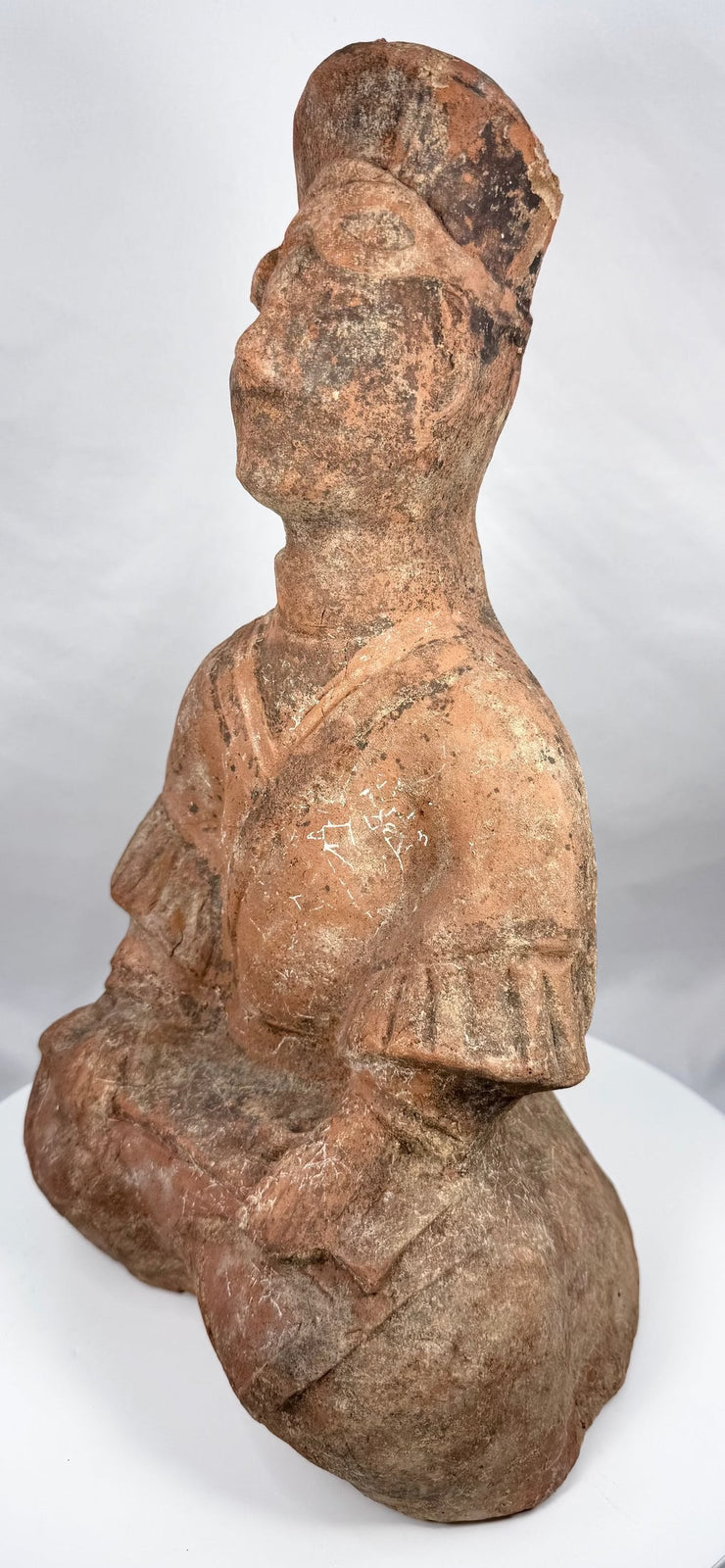 Han Dynasty terracotta figure with hands positioned across lap