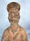 Ancient terracotta mingqi figure with archaeological surface deposits