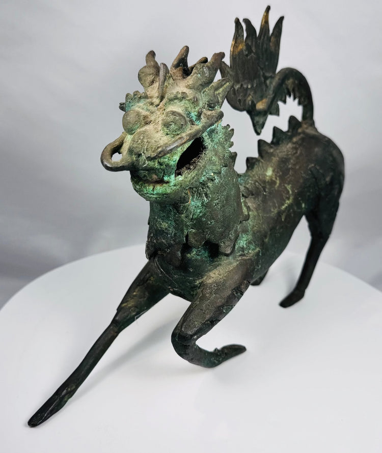 Rear view of the qilin’s tall arched ornamental tail