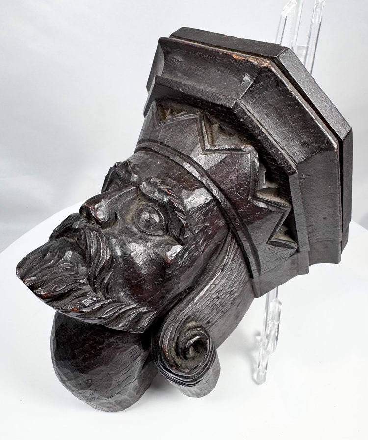 Front view of a Gothic Revival bearded male corbel carving