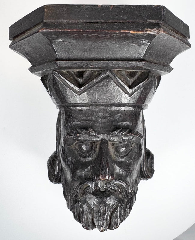 Close-up of the deeply carved face and divided beard