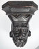 Close-up of the deeply carved face and divided beard