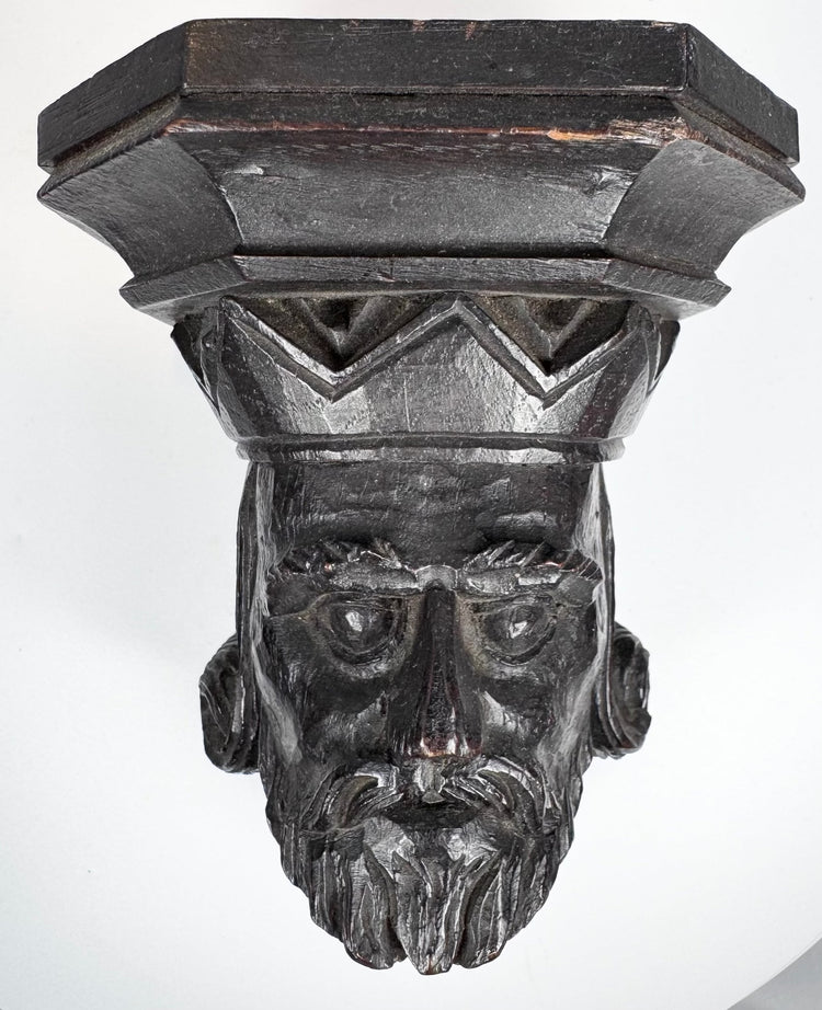 Close-up of the deeply carved face and divided beard