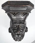 Close-up of the deeply carved face and divided beard