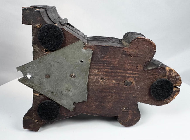 Dark-stained wooden corbel with reddish-brown areas of wear